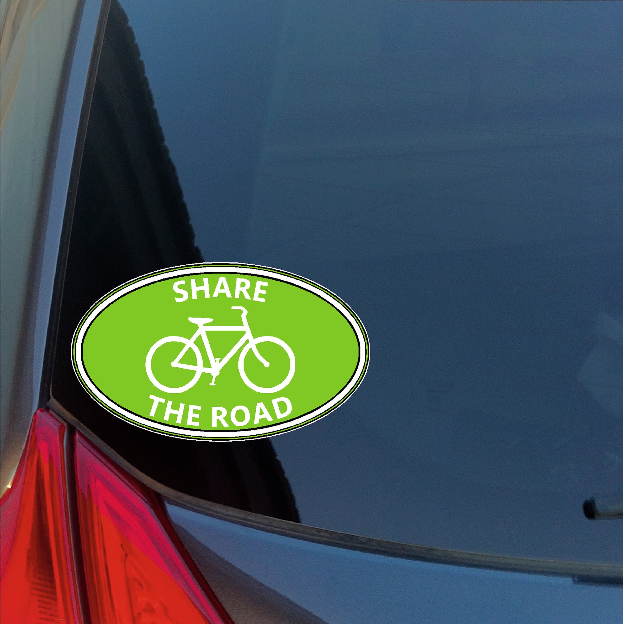 Share The Road bicycle oval sticker with green bike lane background