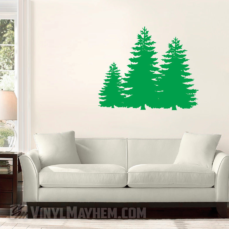 Green tree wall decal on a white wall above a gray sofa.