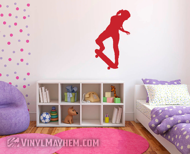 Children's room with a skateboarder silhouette wall decal, colorful polka dot wall, and purple furniture.